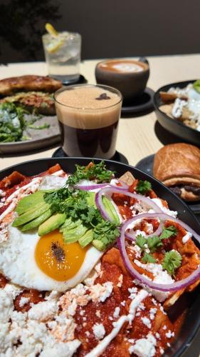 a plate of food with an egg on a table at Espacio Lienzo in Oaxaca City