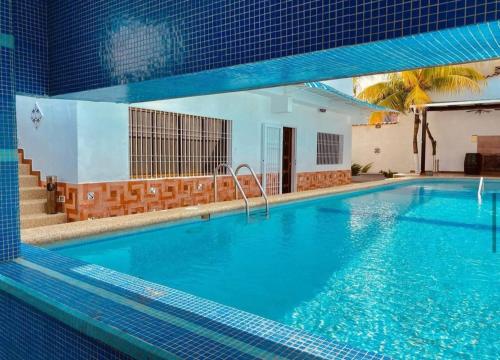 a large swimming pool with blue water at Tu casa en las playas de Chichiriviche para 20 pax in Chichiriviche