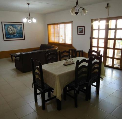 a living room with a table and chairs and a couch at Tu casa en las playas de Chichiriviche para 20 pax in Chichiriviche