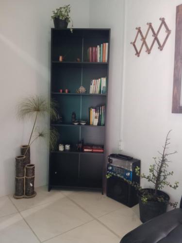 a black book shelf with books in a room at Casa Campestre en Guarne in Guarne