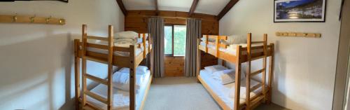 a room with two bunk beds in a house at Lakepines in Jindabyne