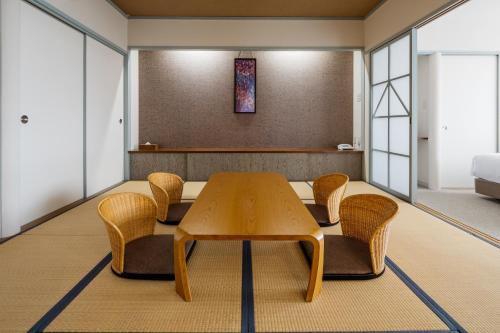 a dining room with a table and chairs at Infinito Hotel and Spa in Shirahama