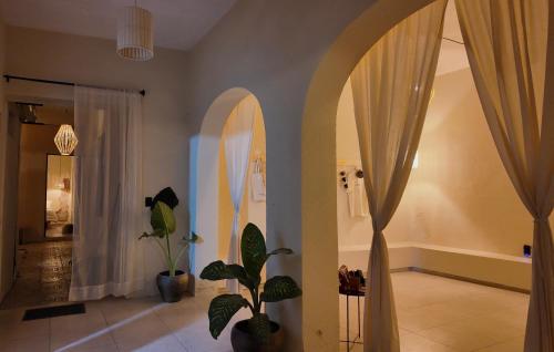 a room with a hallway with curtains and a plant at Espacio Lienzo in Oaxaca City