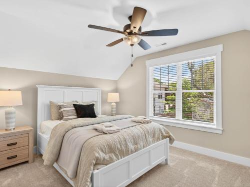a bedroom with a bed and a ceiling fan at The Salty Ace in Oak Island