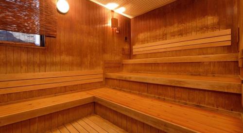 an empty sauna with wooden walls and wooden floors at Nanaironoyu Hotel in Takeo