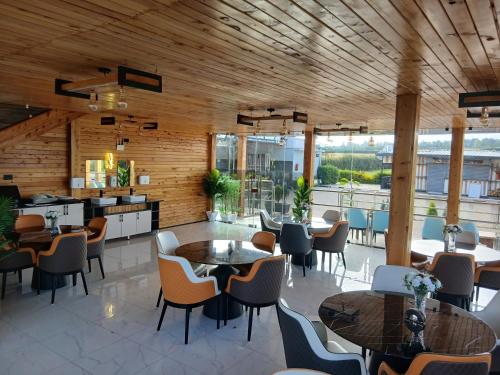 a restaurant with tables and chairs in a room at Esiankiki Resort & Spa - Nanyuki in Nanyuki