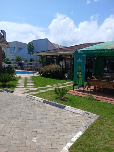 a pavilion with a bench next to a building at Esiankiki Resort & Spa - Nanyuki in Nanyuki