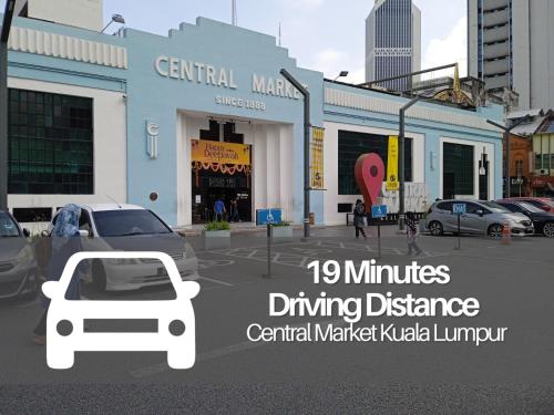 a building with a car parked in a parking lot at Seeds Hotel Premier Sri Petaling in Kuala Lumpur