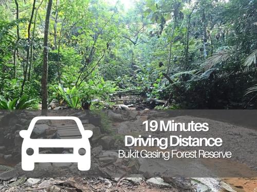 a sign with a white car in a forest at Seeds Hotel Premier Sri Petaling in Kuala Lumpur