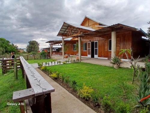 a wooden house with a bench in front of it at Hermosa Cabaña Familiar en Oaxaca in Oaxaca City