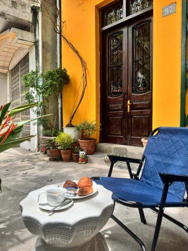 un patio con una mesa, una silla y una puerta en Hà Nội Mái Hiên Boutique Stay, en Hanói