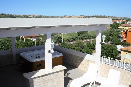 a balcony with a hot tub on top of a building at GFH - Hotel Sole Resort & Spa in Marotta