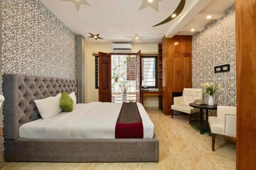 a bedroom with a large bed and a desk at Hanoi Family Homestay in Hanoi