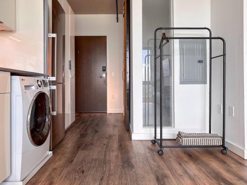 a laundry room with a washing machine and a door at River View Suite - The Wharf DC by Monthier in Washington