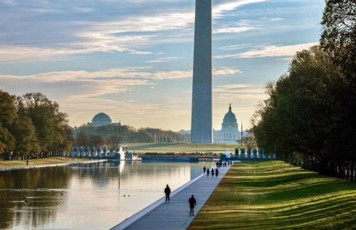 a group of people walking around the washington monument at River View Suite - The Wharf DC by Monthier in Washington