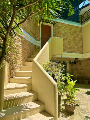a set of stairs leading to a building at Castle View Hotel Samal in Magamomo