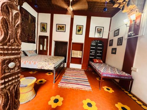 a living room with two beds and a fireplace at The Prince Haveli in Bikaner