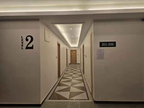 a hallway in a building with a sign on the wall at The Pinecrest in Gangtok