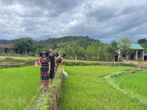 a group of people walking through a field at Vuglamping in Hue