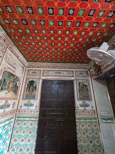 a room with a ceiling and a door with tiles at The Prince Haveli in Bikaner