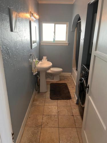 a bathroom with a sink and a toilet and a window at Downtown Neighborhood Room 2 in Phoenix