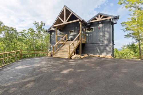 a wooden house with a porch and a wooden railing at Golden Oaks Cabin home in Walland
