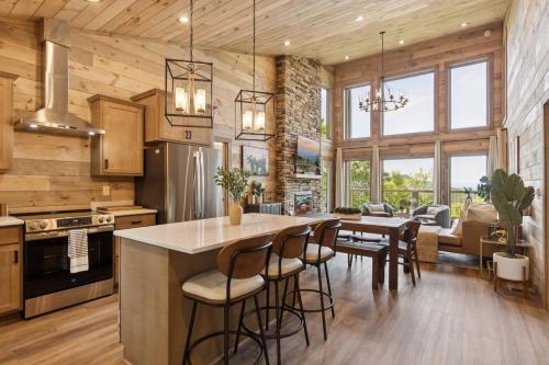 a kitchen with a large island with bar stools at Golden Oaks Cabin home in Walland