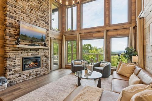 a living room with a fireplace and a stone wall at Golden Oaks Cabin home in Walland
