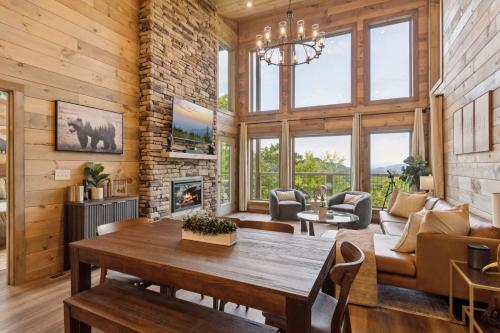 a living room with a table and a fireplace at Golden Oaks Cabin home in Walland