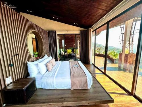a bedroom with a bed and a balcony at Viettrekking Sapa in Lo Sui Tong