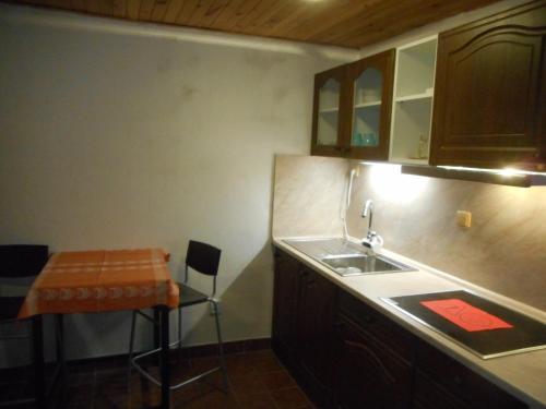 a small kitchen with a sink and a table at Horský Ranč in Pec pod Sněžkou