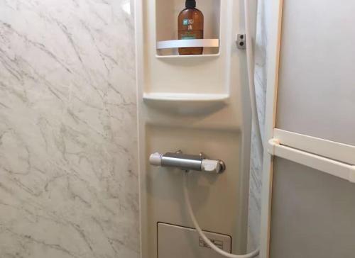 a bottle of wine is plugged into a refrigerator at 花迹民宿二号馆201 通天阁天王寺步行圈 心斋桥日本桥4分钟车程 in Osaka