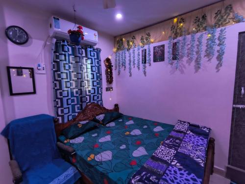 a bedroom with a bed and a wall with decorations at Blue Diamond in Chennai