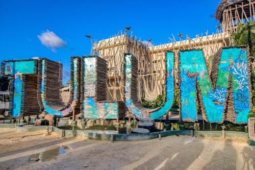 a building with the word art painted on it at Aldea Zama - Lujo Natural en el Corazón de Tulum in Tulum