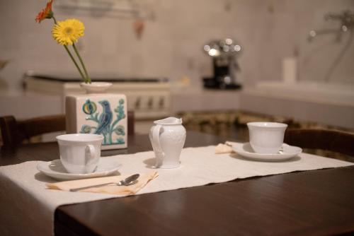 ピティリアーノにあるAppartamenti del Ceccottinoの花瓶と2杯のテーブル
