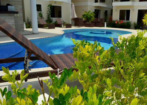 a swimming pool in the middle of a resort at Residencial Portinari LTDA in Porto Seguro