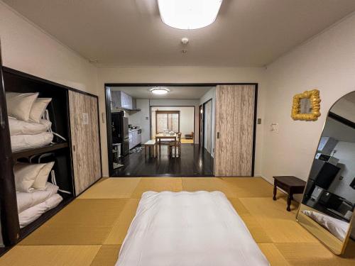 a bedroom with a bed and a dining room at Imagine Annex in Kyoto