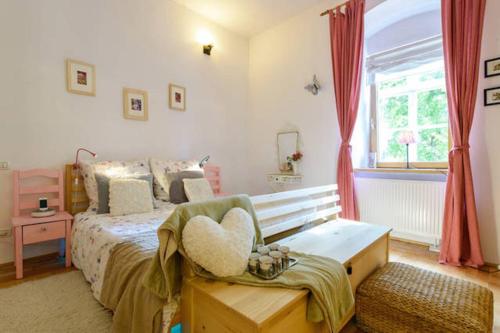 a bedroom with a bed with a heart pillow on it at Transylvania Residence Brasov in Braşov