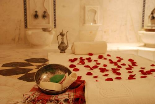 アランヤにあるRose Garden Apart Hotelのテーブルの上に赤いバラの花びらを飾った部屋