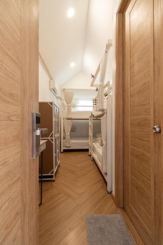 a hallway with a room with bunk beds and a door at SherVa101 Home and Hostel in Chiang Mai
