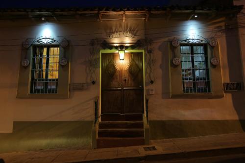 a front door of a building at night at Casa Verde Hostal in Sucre