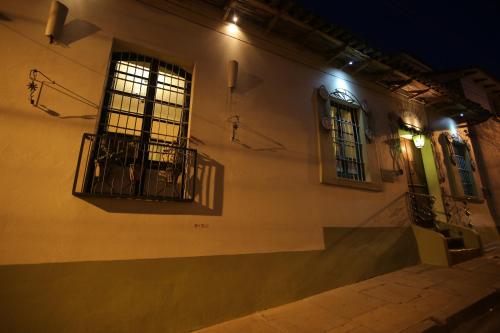 a building with barred windows on a street at night at Casa Verde Hostal in Sucre