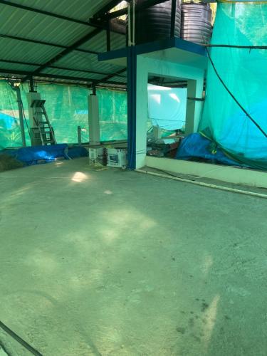 an empty room with blue walls and a room with a ladder at Mangala Residency in Cola