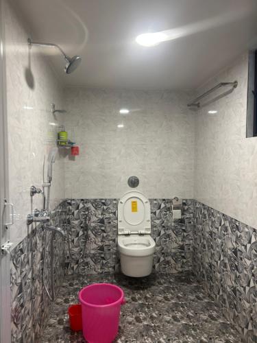 a bathroom with a toilet and a shower at Mangala Residency in Cola
