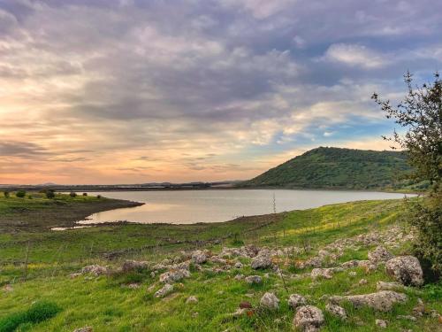 a large body of water with a hill at Matar baYaar מטר ביער in El-Rom