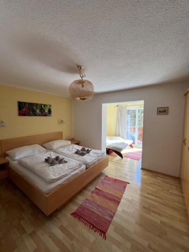a bedroom with a large bed and a large window at am mühlbach - einfach sein, mit Gemeinschaftsküche in Dorfgastein