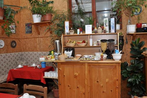 a restaurant with a table and a counter with food at Pension Nika in Český Krumlov