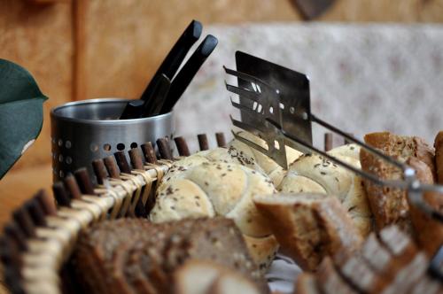 a basket of food with utensils and a cup at Pension Nika in Český Krumlov