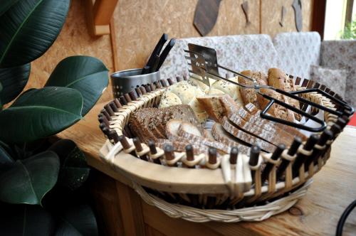 a basket filled with bread and breadsticks on a table at Pension Nika in Český Krumlov
