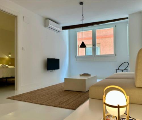 a living room with a couch and a table at Urdaibaibai Desing in Bermeo